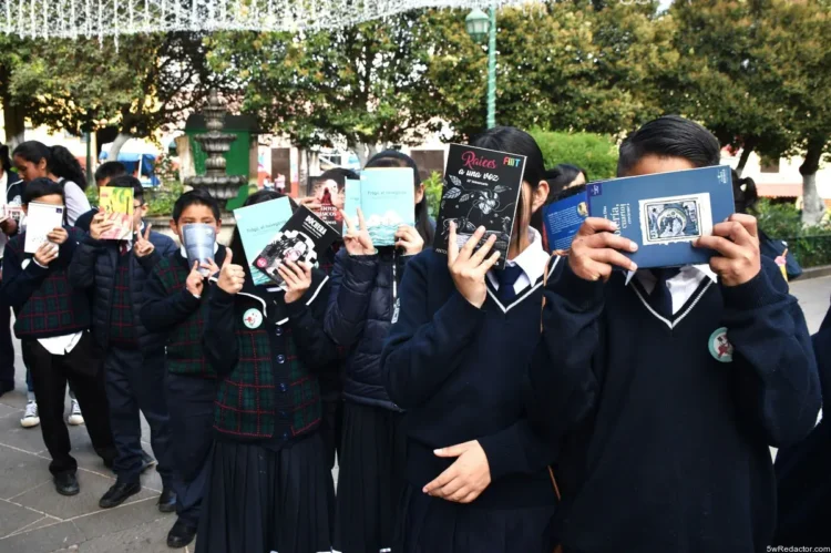 Libros en manos de estudiantes en una fila en la escuela.